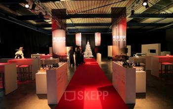 Chic Koopvaardijweg 2 office space rental in Oosterhout Nb with a stylish red carpet leading to event setup and attendees networking.