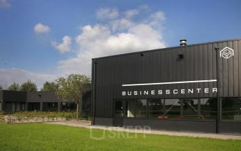 Modern Business Center exterior at Koopvaardijweg 2, Oosterhout Nb, ideal for an office space rental with a lush green lawn.
