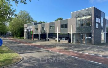 Modern office building at Abdis van Thornstraat 74, Oosterhout Nb, available for office space rental with large windows and a sleek exterior design.