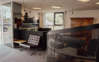 Office space with modern furniture and a spiral staircase, suitable for rental at Abdis van Thornstraat 74, Oosterhout Nb.