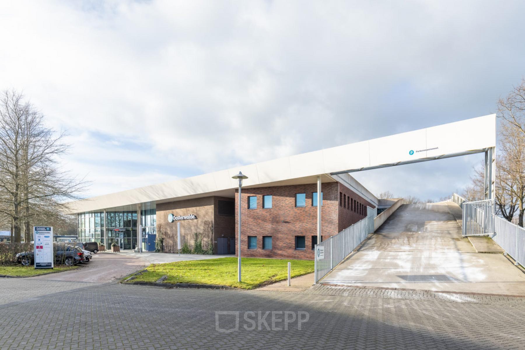 Exterior view of an office building located at Veengang 1, Oosterwolde, ideal for office space rental.