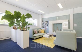 Bright office space at Leeghwaterstraat 25, Reeuwijk, featuring comfy seating, decorative plants, and a cozy ambiance, ideal for an office space rental.