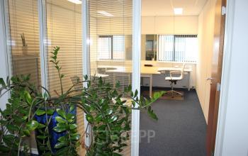 Bright office space at Leeghwaterstraat 25, Reeuwijk, featuring a furnished interior with desks and chairs, perfect for rent office space needs.