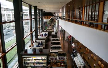 Modern office space rental at Ericssonstraat 2, Rijen, featuring a spacious cafeteria with seating and large windows.