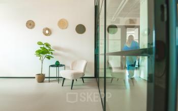 Bright office space at Lange Kleiweg 50-62, Rijswijk, featuring a modern interior with seating and decorative elements, ideal for office space rental.