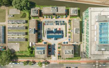 Aerial view of the office complex at Lange Kleiweg 50-62. The buildings surround a central parking area integrated into the layout, creating a convenient space for office space rental with accessible parking options.