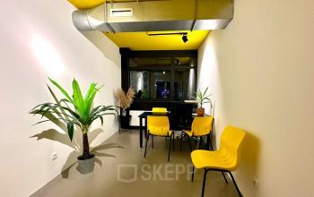 Bright office space at Volmerlaan 7 in Rijswijk featuring yellow chairs and plants, ideal for a vibrant workspace. Consider this office space rental for a fresh and modern business environment.