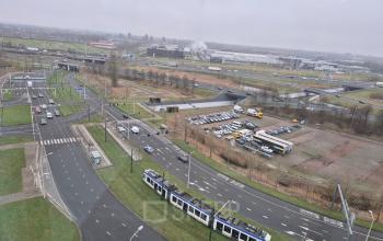 View from Laan van Zuid Hoorn 70, Rijswijk, showcasing roads with traffic and a tram passing by, adjacent to parking and industrial areas.