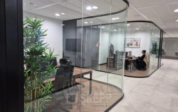 Modern office space rental at Laan van Zuid Hoorn 70, Rijswijk, featuring sleek glass partitions and workstations. Professional setting ideal for collaborative work and meetings.