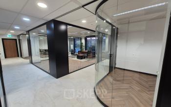 Modern office space at JC van Markenlaan 3, Rijswijk showcasing sleek glass walls and minimalist design ideal for office space rental.