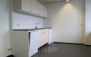 Bright office pantry available for rent at JC van Markenlaan 3, Rijswijk, featuring modern cabinetry and tile flooring.