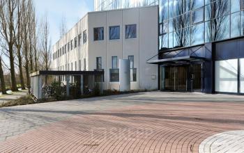 Exterior view of the office building at Patrijsweg 4-140, Rijswijk, featuring modern glass and concrete architecture.