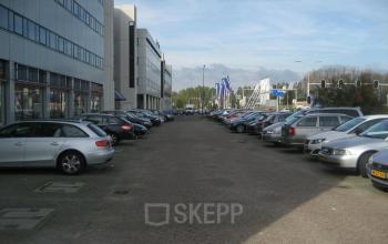 Parking area in front of office building at Patrijsweg 4-140, Rijswijk, with several cars parked along both sides.