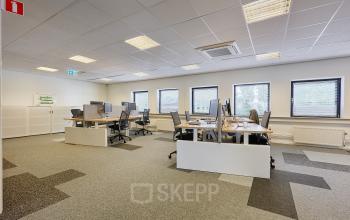 Spacious office to rent at Patrijsweg 4-140, Rijswijk, featuring workstations with monitors, chairs, and windows for natural light.