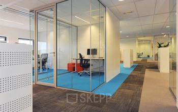 Modern office space with glass-enclosed private offices and carpeted floors located at Patrijsweg 4-140, Rijswijk. Ideal office space rental for professional environments.