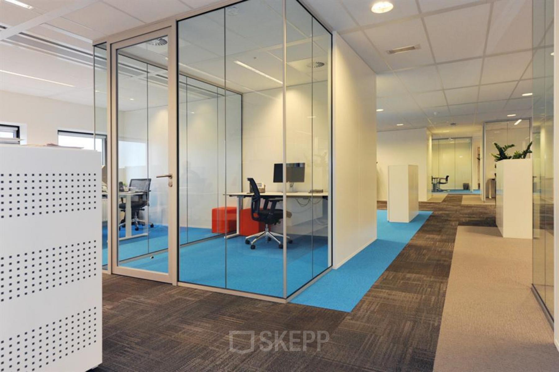 Modern office space with glass-enclosed private offices and carpeted floors located at Patrijsweg 4-140, Rijswijk. Ideal office space rental for professional environments.