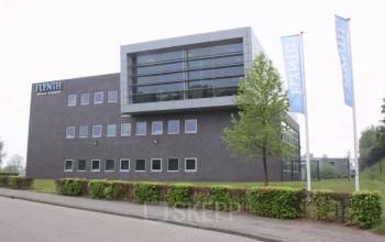 Exterior view of a modern office building located at Noordhoven 19, Roermond. The sleek architecture showcases a professional environment ideal for office space rental.