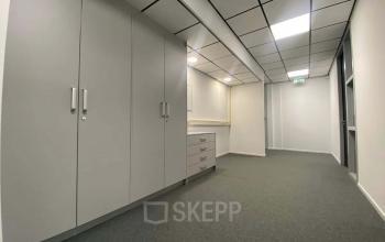 Interior hallway of office space rental at Noordhoven 19, Roermond, featuring built-in storage and neutral decor.
