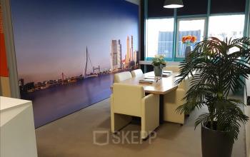 Modern office space rental at Corkstraat 46, Rotterdam Airport, featuring a vibrant cityscape mural and stylish furnishings.