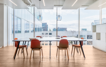Bright and modern office space rental in Rotterdam Alexander, featuring a spacious meeting area with large windows and contemporary furnishings.