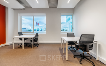 Interior of an office space at Marten Meesweg 25-G, Rotterdam Alexander with desks and chairs facing bright windows. Ideal for office space rental.