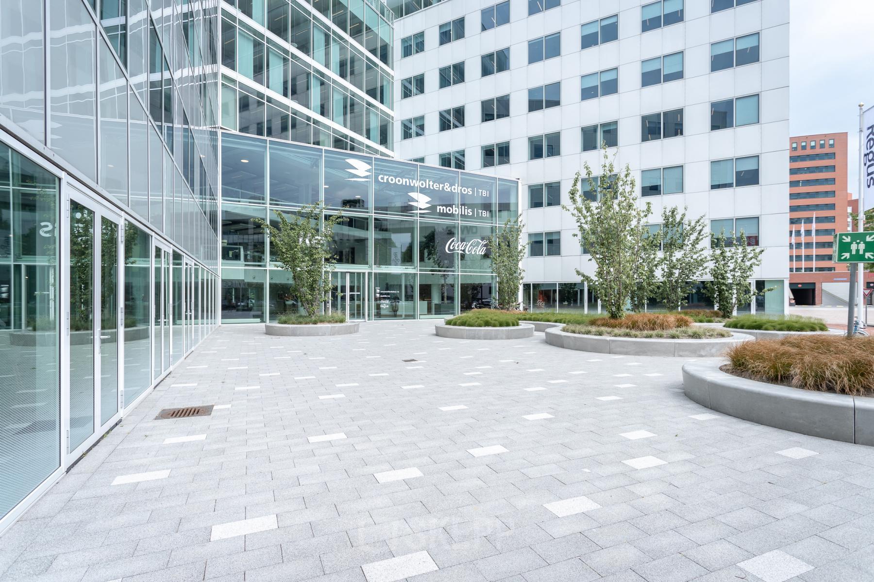 Exterior view of office building at Marten Meesweg 25-G in Rotterdam Alexander, with modern architecture and leafy surroundings, ideal for office space rental.
