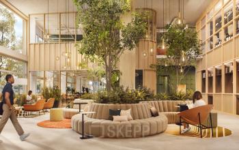 Modern lobby area at Marten Meesweg 101, Rotterdam Alexander, featuring stylish seating and natural elements. Ideal office space rental environment with people engaged in casual discussions.