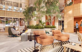 Modern office in Rotterdam Alexander with natural elements, featuring comfortable seating and people engaged in discussions. Ideal for office space rental.