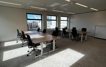 Bright office space with several black office chairs and wooden desks, available for rent at George Hintzenweg 77 - 89, Rotterdam Alexander.