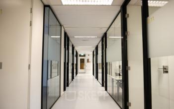 Corridor with glass-walled offices and modern lighting at Marten Meesweg 8-10, Rotterdam Alexander, Rotterdam, ideal for office space rental.