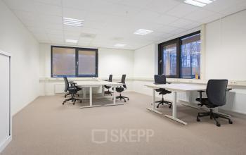 Spacious, well-lit office to rent at Marten Meesweg 8-10, Rotterdam Alexander, featuring multiple desks and chairs by large windows.