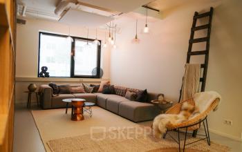 Comfortable lounge area in an office at Marten Meesweg 8-10, Rotterdam Alexander, featuring cozy seating and stylish decor.