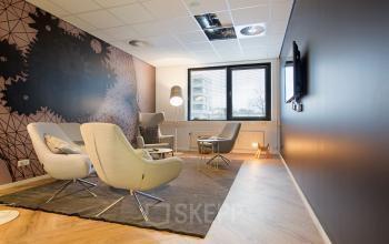 Comfortable office to rent at Marten Meesweg 8-10, Rotterdam Alexander, featuring stylish chairs, a modern design, and natural light from large windows.