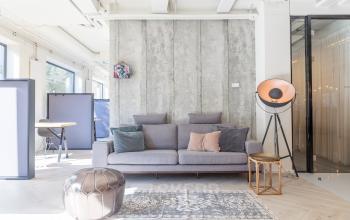 Modern office to rent at Marten Meesweg 8-10, Rotterdam Alexander, featuring comfortable seating with pillows, stylish lamp, and natural light.