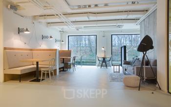 Bright open workspace in Marten Meesweg 8-10, Rotterdam Alexander, with modern furnishings, natural light, and versatile seating arrangements for rent office space.