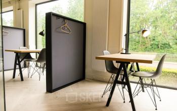 Modern office space at Marten Meesweg 8-10, Rotterdam Alexander with large windows, natural light, and minimalist furnishings including desks and chairs.