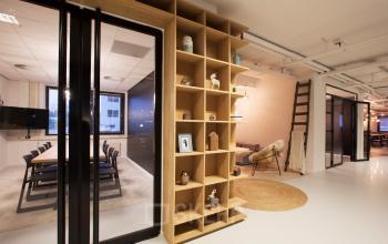Modern office interior at Marten Meesweg 8-10, Rotterdam Alexander with a conference room, open floor plan, and stylish shelving.