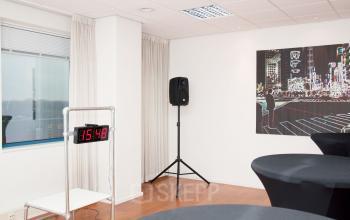 Interior of an office space rental at Hoofdweg 66, Rotterdam Alexander, with a timer, speaker, and modern artwork on the wall.