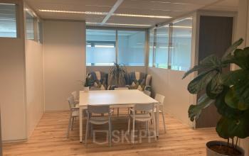 Well-lit office space with a white table, chairs, and lounge seating at Hoofdweg 66, Rotterdam Alexander.