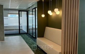 Modern office space at Bahialaan 100, Rotterdam Brainpark featuring a minimalist lounge area, perfect for rent office space needs.