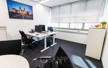 Bright office space at Weena 290, Rotterdam Central Station, featuring modern furniture and large windows, ideal for office space rental.