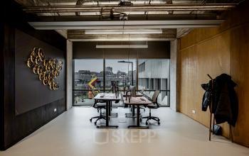 Modern office space in Hofplein 19, Rotterdam with sleek decor, large windows, and contemporary furnishings, offering a professional environment ideal for office space rental.