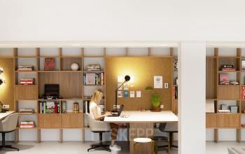 Interior view of a modern office space at Hofplein 20, Rotterdam Central Station, with a worker seated at a desk surrounded by shelves and working on a laptop.