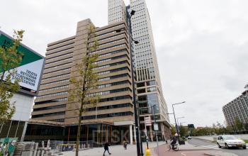 Exterior view of office at Weena 750, near Rotterdam Central Station, showing modern high-rise building with surrounding infrastructure.