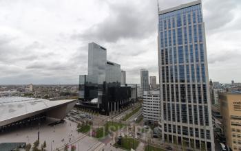 Tall office buildings near Rotterdam Central Station, including Weena 750, with a view of surrounding architecture and streets.