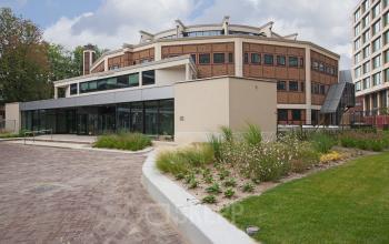 Exterior view of Kruisplein 15-25 office building near Rotterdam Central Station with modern architectural design and landscaped surroundings.