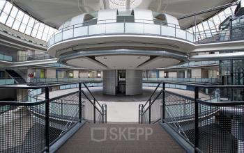 Spacious interior of office space rental at Kruisplein 15-25, Rotterdam Central Station, featuring modern architectural design and an open layout with multiple floors and large windows.