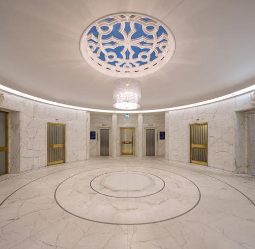 Luxurious marble lobby with a decorative ceiling and multiple elevators at Blaak 34, Rotterdam Center, providing office space rental.