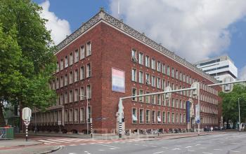 Modern office space rental at Schiekade 830, in Rotterdam Center, with a brick facade and large windows.