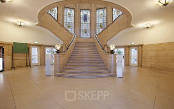 Elegant entrance of Schiekade 830, showcasing grand staircases for a distinguished office space rental in Rotterdam Center.
